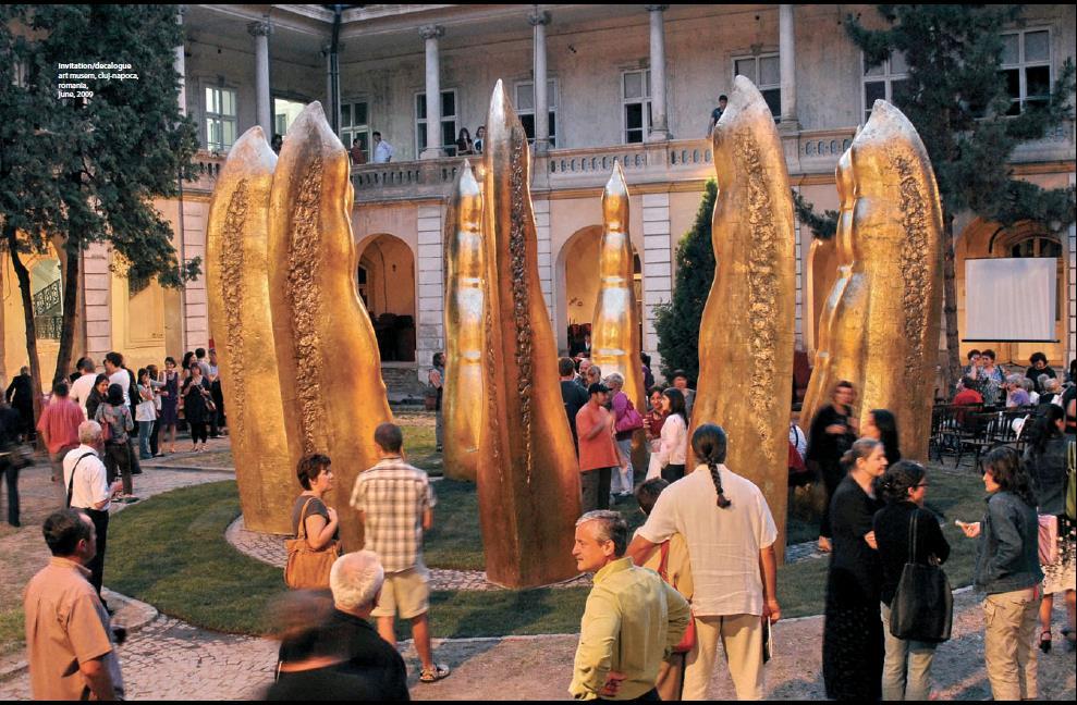 Invitation/ Decalogue gold on fiber glass, H. 4, 65 cm A.D. 2009 The monument consists of 10 golden pillars, around 5 meters high, resembling human fingers.