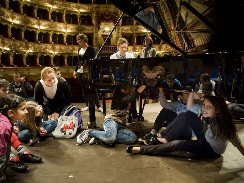 AN INTRODUCTION TO FEEL THE MUSIC Sliding on their sock- clad feet, a gaggle of children squeeze themselves under the belly of the Steinway as the Norwegian pianist Leif Ove Andsnes invites them to