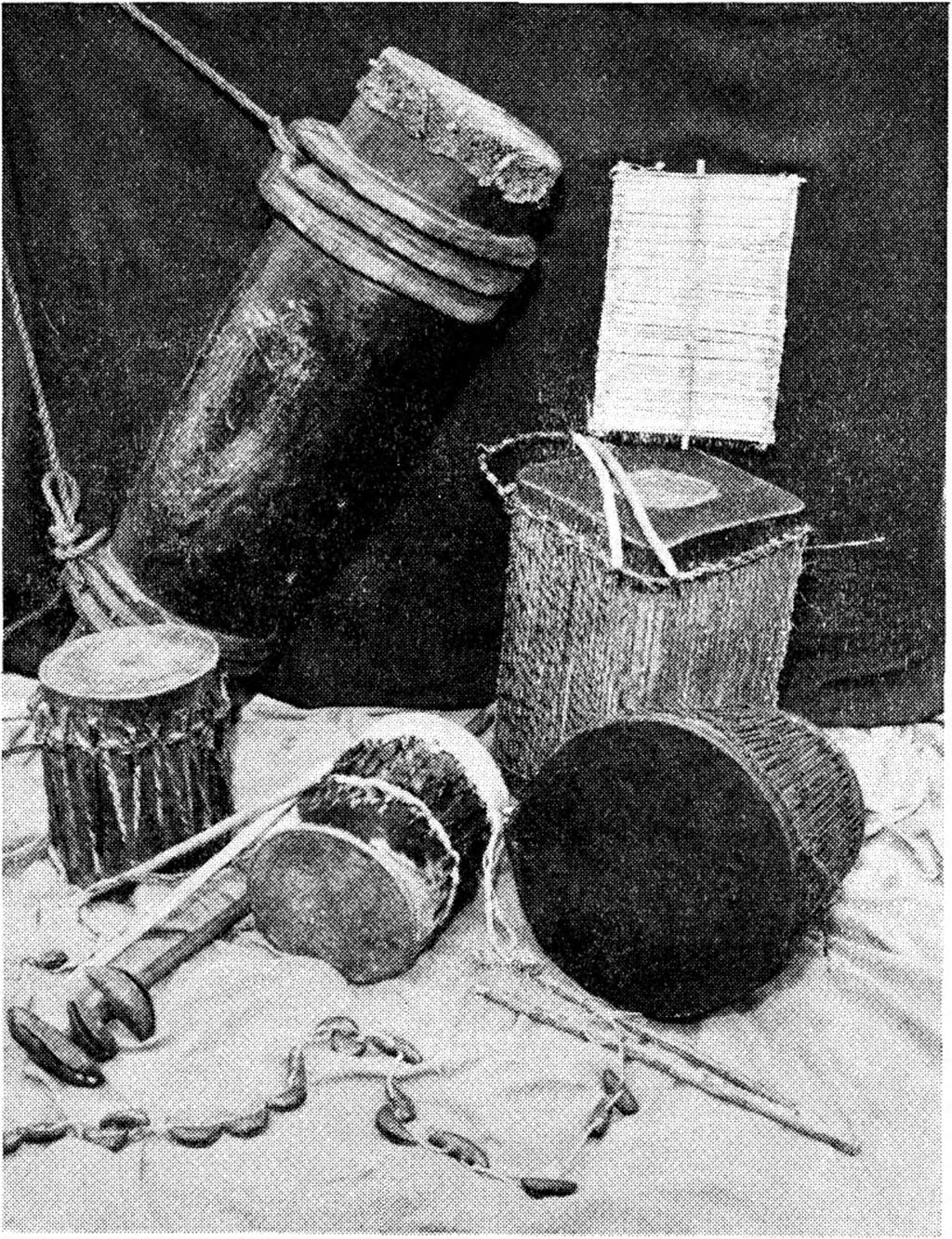 Length 10 inches, diameter 71 inches. (Mid Right) ATENESU DRUM. Made from 4 gall, tin covered with ox hide top and bottom. Teso tribe (Elgon Nyanza District of Kenya). (Lower Right) ATENESU DRUM.