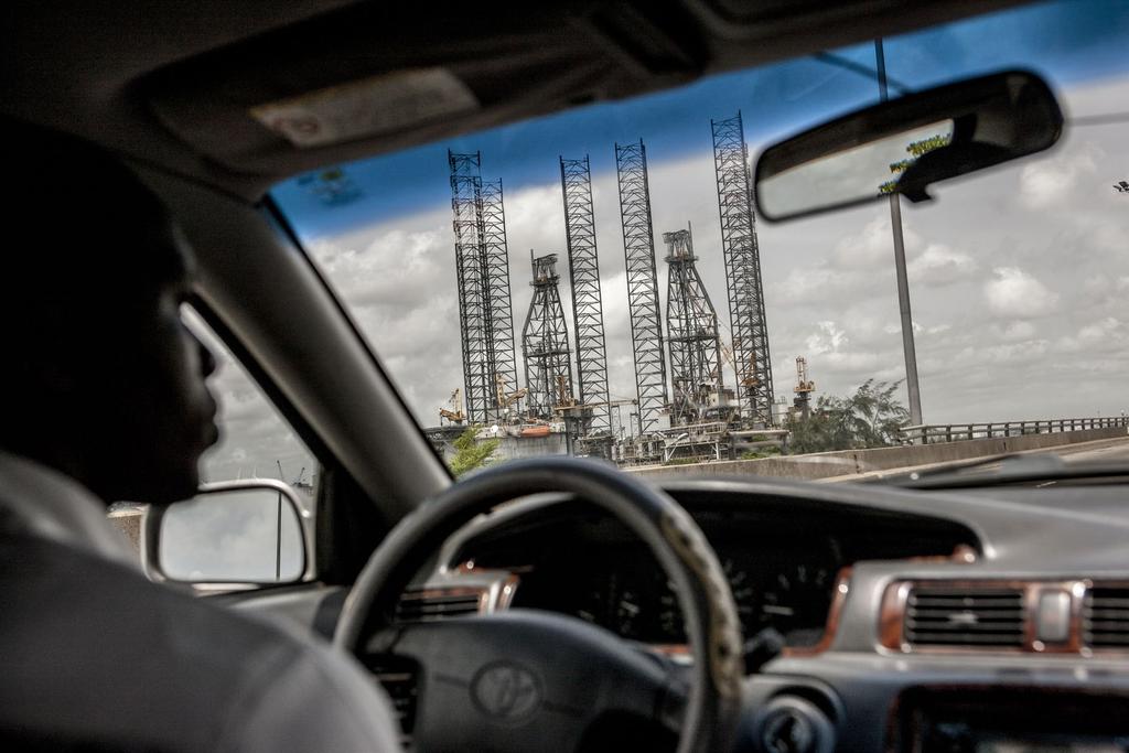 Lagos, Nigeria. An oil rig moored at the port seen through a taxi windshield.
