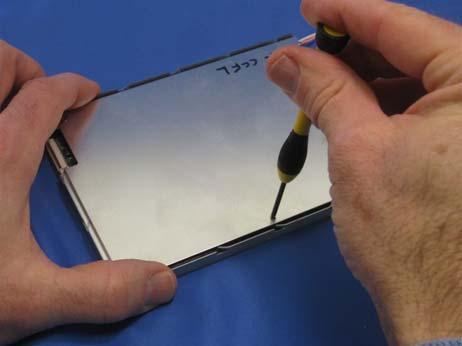 Place the back cover on the display and then replace the (5) screws on the back of the display as