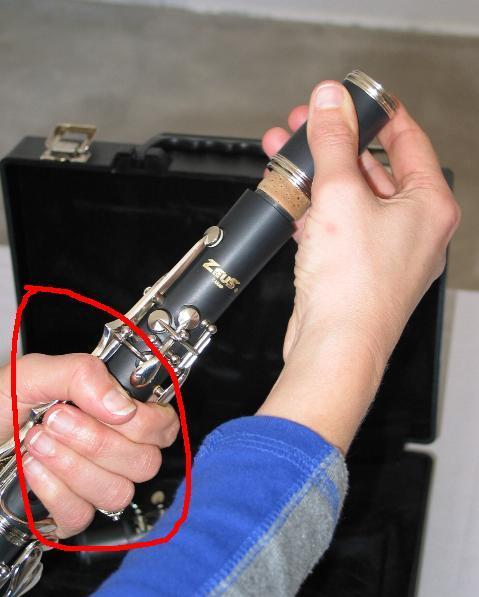 Remove the mouthpiece from the case and take off the ligature (the