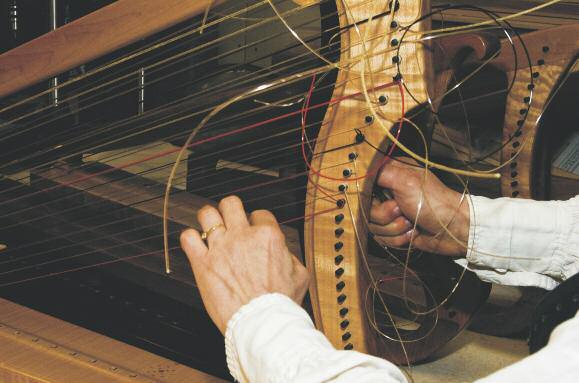 Below: Each harp style has a different string schedule, since they re all different sizes or materials, Catherine says as she works on a Boston Harp.