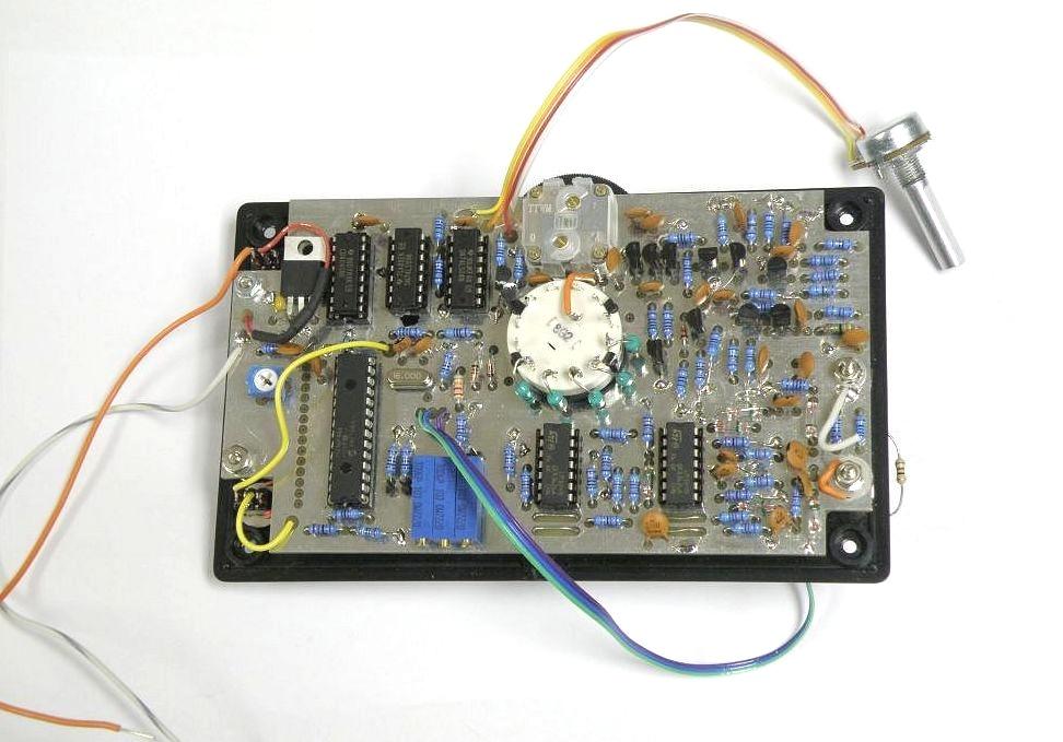 The completed circuit board was mounted to the cover of the box and wires from the circuit board were connected to the switches and binding posts.