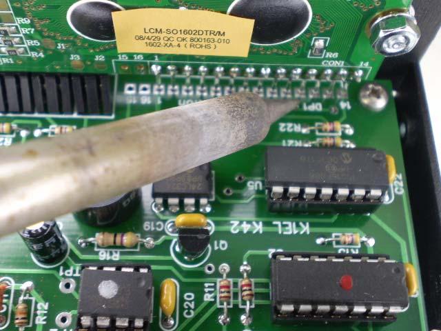 Now very carefully sneak in with your soldering iron and tack solder two pins on the