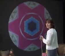 Figure 1. Captured image of a person having fun in the Musikalscope. The video camera is at the bottom of the 170 inch screen. system are played to accompany the background music.