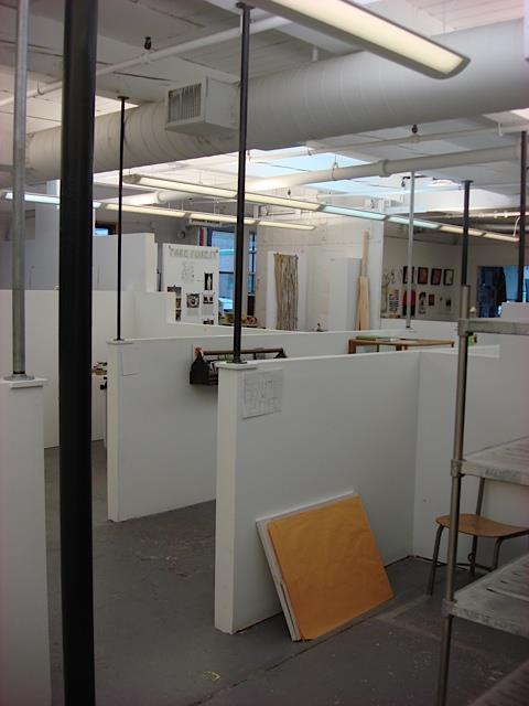 Running With Scissors uses waist-high partitions to separate studio areas.
