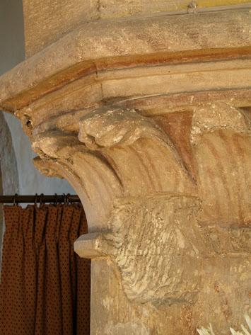 A further dating feature is the face carved between arches, in the spandrel (right), also it shows a plastered wall around it; the entire nave is