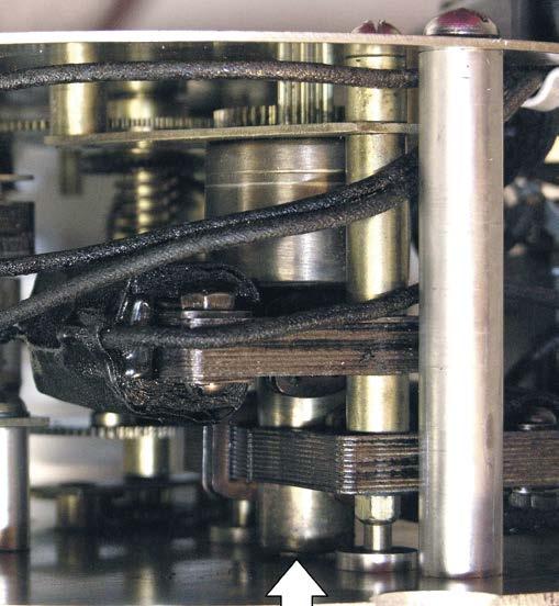 Note slip clutch on the seconds hand shaft that allows the 1 rpm motor to run while hand is held.
