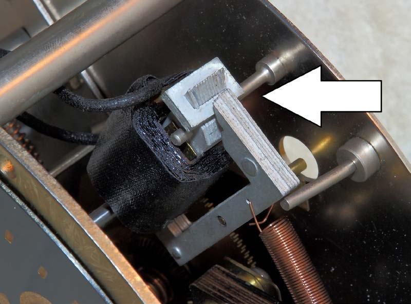 This top shaft goes to an opening in the case where a key can manually adjust that specific clock. Figure 17.
