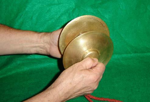 For finger cymbals substitutes, place two different sized spoons right side up next to each other on a thick towel and strike the cups with two other spoons.