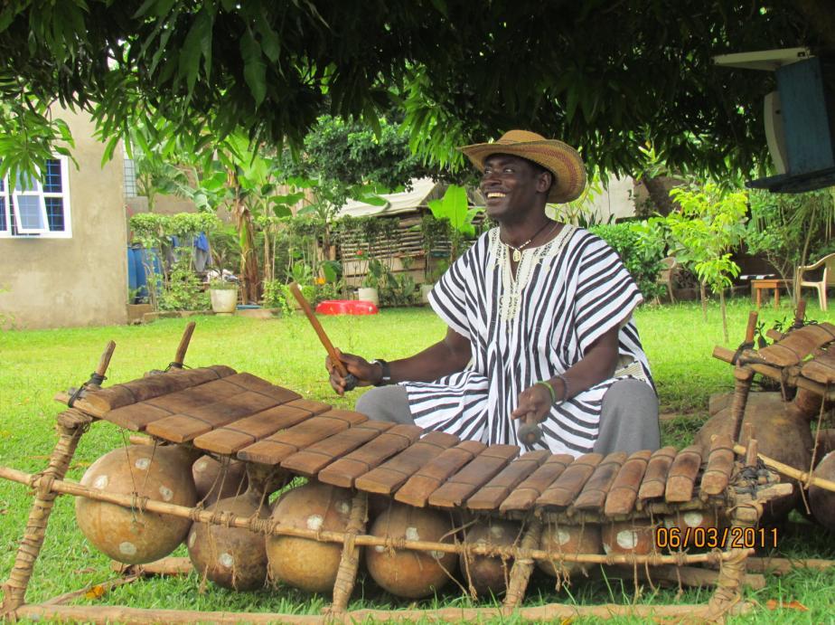 Figure 3 A gyil player playing the kpagru timeline with the back end of the mallet Picture by Becca Templeton Equally important in the musical organization of the gyil is the kuɔr drum, an instrument