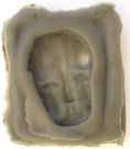 Figure 9: Imprint of Mask, a self-portrait carved from a potato. Red sealing wax.