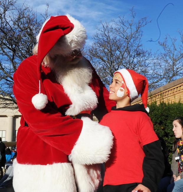 Parade on Santa Claus and Lorenzo Carmona, 9, of Brockton,