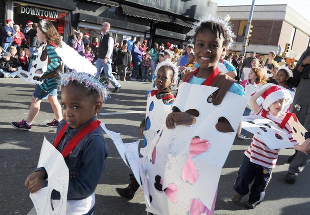 of Brockton, a Girl Scout marches in the 25th annual Downtown
