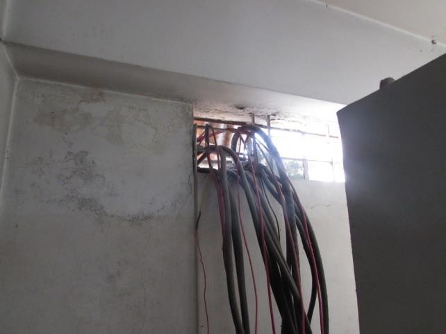 FINDING NO: E- 20 CATEGORY:CABLE & CABLE SUPPORTS Cable passes through wall are not protected and not supported.