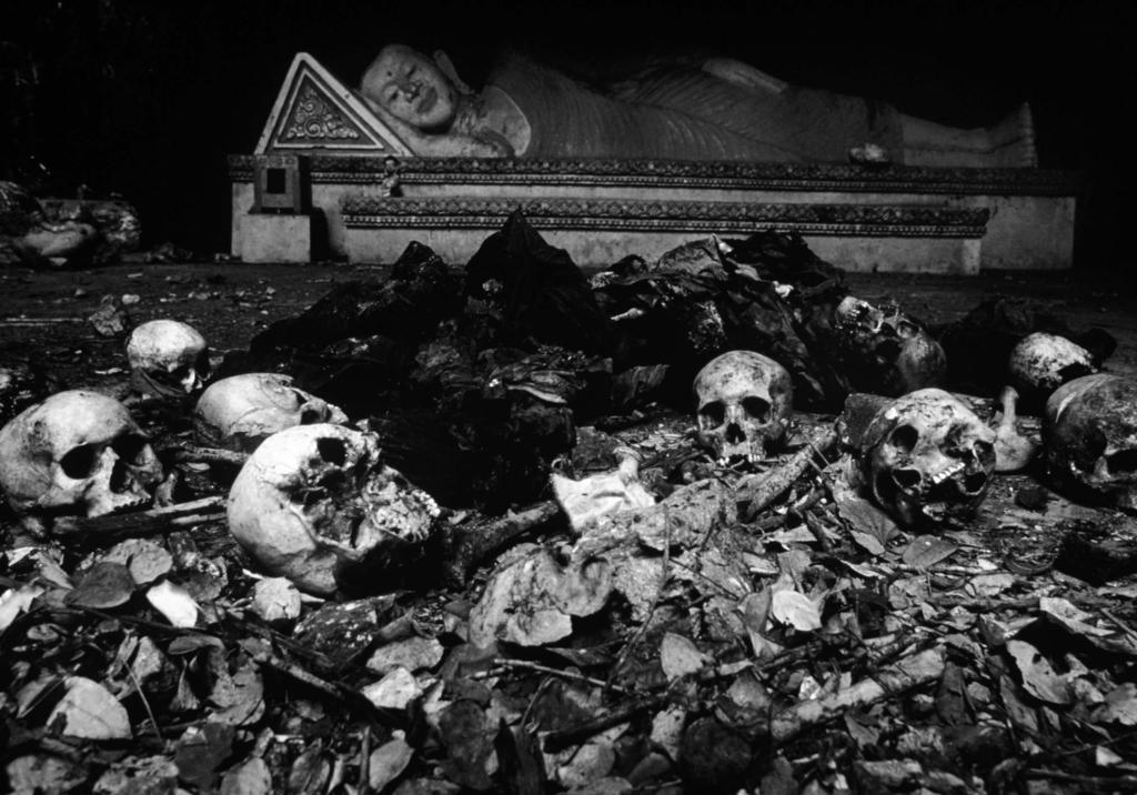 Figure 3 Human remains, Cambodia, 1980. Philip Jones Griffiths/ Magnum Photos. soldier peering over some sandbags, gun in hand (Life in Northern Ireland, 1973, in Jones Griffiths, 1996).