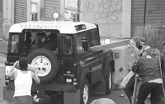 Figure 1 Giuliani (in black balaclava helmet) pictured behind a police jeep during the