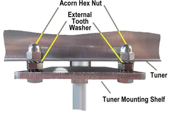 Once positioned correctly, tighten all of the hardware holding the tuner shelf assembly to the lower base tube.