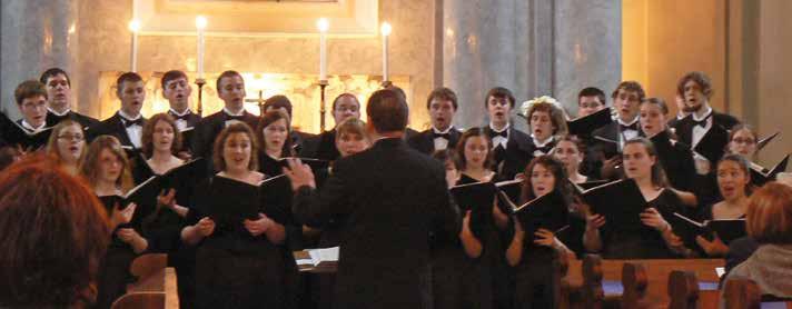Kenneth Kosche conduts a choir performing in Tisovec, Slovakia. there for worship and thus could avoid a night out during the week.