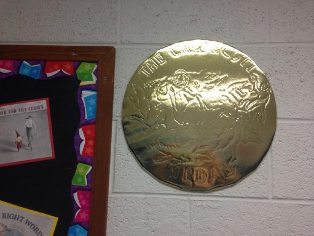I projected the picture of the Caldecott medal onto the foil wrapped cardboard and traced parts with a dull pencil. http://www.ala.