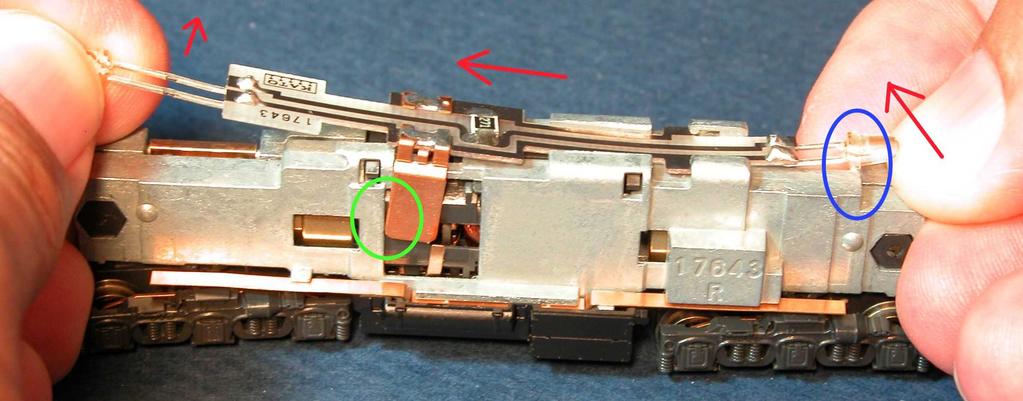 The bottom of the LED (blue circle) hooks on the frame. So you must lift that LED over the frame while moving the board rearward.