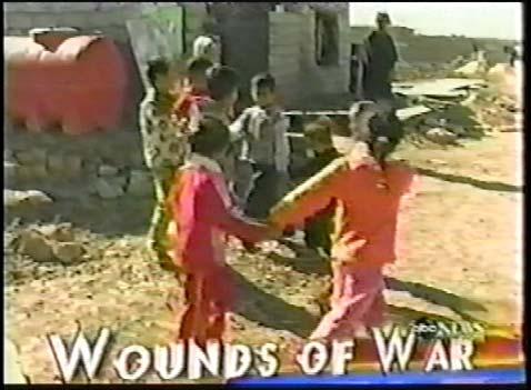 The graphic cuts to a shot of animated text that reads Wounds of War and we see a shot of children playing.