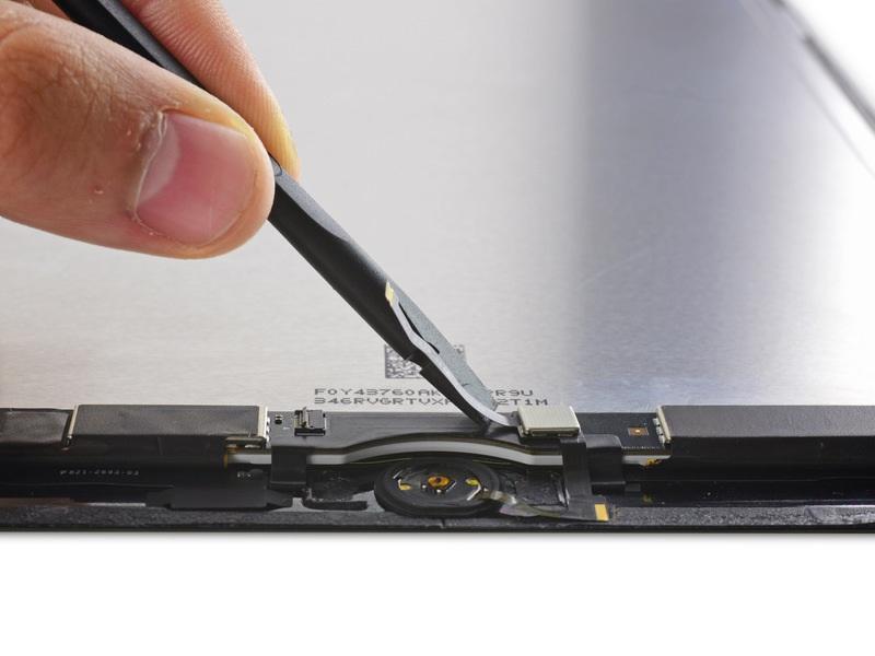 Step 39 Use the flat end of a spudger to peel up the Home Button ribbon cable and Touch ID control chip.