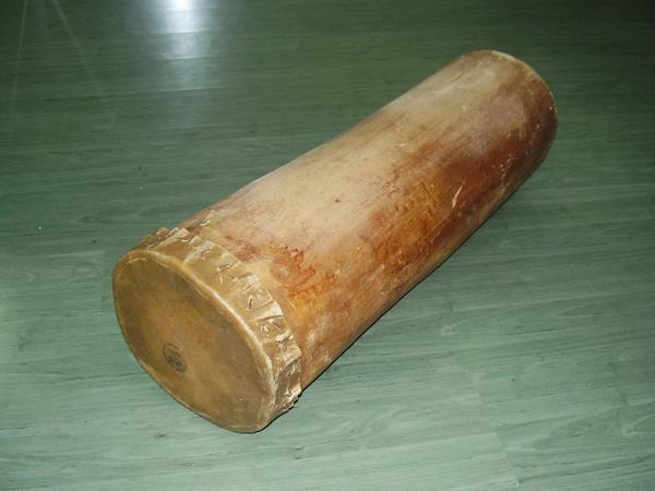 membrane drum made from a split log that lays on