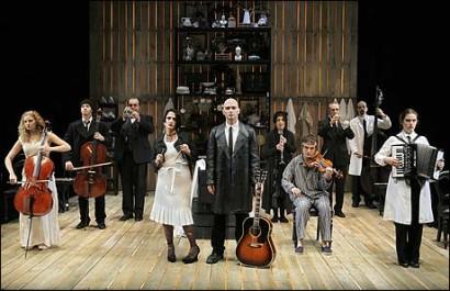 Just as Prince s production was known for its massive scale and the looming beehive curtain, John Doyle s 2004 production (transferred to Broadway in 2005) was notable for its small, claustrophobic