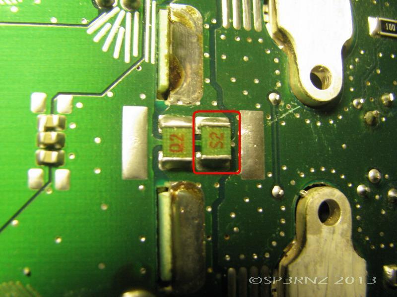 After PCB removal ( no need to disconnect any cables, just gently pull the PCB back and lift it up, and rotate upside down ) we need to locate two capacitors located near PA transistors marked Q2 and