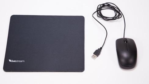 The included mouse pad can be found in the top layer; The mouse is in the middle layer of the