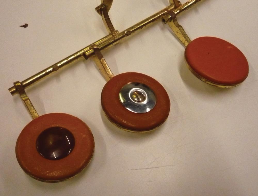Figure 1: (Color online) Three kinds of pads: with a plastic resonator on the left, with a metal resonator in the middle, and without a resonator on the right.