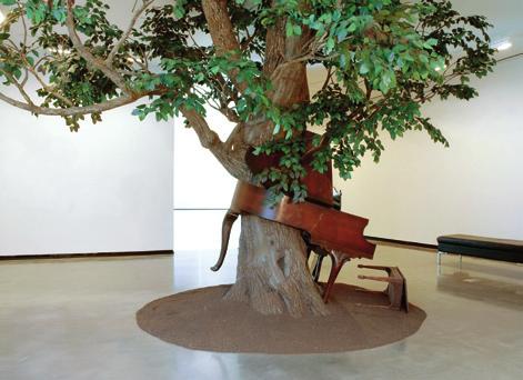 Description of the Artwork Blossom (2007) is a large sculpture consisting of a fabricated, life-size tree growing through a baby grand piano, lifting it off the ground as branches stretch upward.