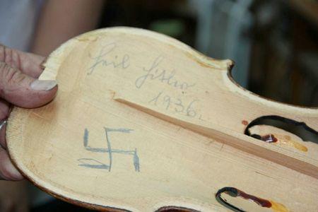 At least one Jewish violinist unwittingly carried a hidden message of hate inside his instrument.