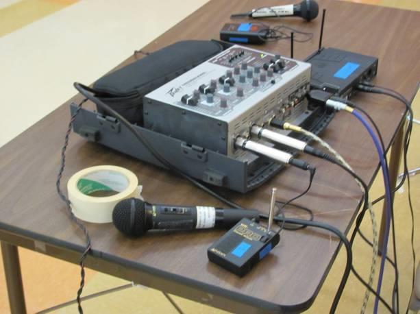 Microphones: The accessory box contains two wireless microphones, one with an