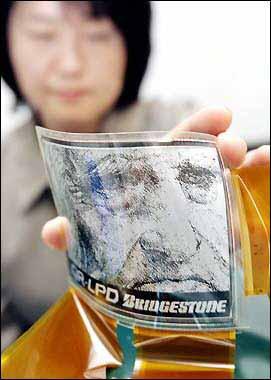 Latest News A Bridgestone employee displays Quick Response Liquid Display (QR- LPD) featuring its nanotechnology already in use for making tires at the company s laboratory in Tokyo 27 December