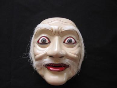 He eventually carves out a character face, smooth the surface with sandpaper and apply layers of color coating. He finishes the mask with the hair, eyebrows and mustache made of goat hair.