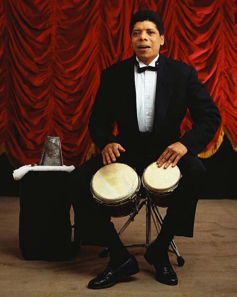 Two drums of different sizes are connected to form a pair of bongo drums. Bongos are held between the knees and are played sitting down. The single drumhead can be hit with the hands or fingers.