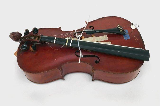 A cello from the Henry Lea Elementary School in Philadelphia. The neck, tailpiece and endpin are all detached from the body.