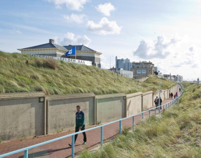 A panoramic view of the Museum Beelden aan Zee and the building from the promenade located between the building and the beach.