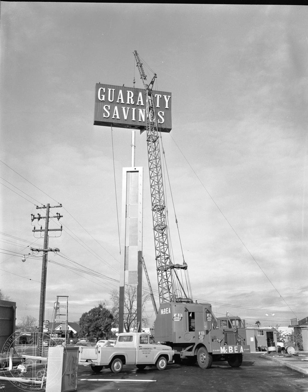 [67] Guaranty Savings, 1962 - Up, up, up it goes. hoisted into the sky by a giant crane.