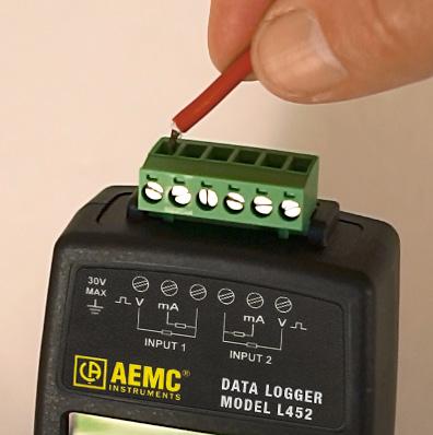 Figure 24. Inserting a lead into the terminal strip 4. Connect the second probe, signal conditioner, or sensor (if used).