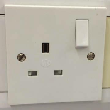 22 7 (c) The photograph shows a UK mains electrical plug socket.