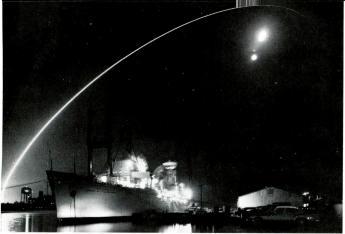 1 2 (1) A Minuteman intercontinental ballistic missile streaks down the Eastern Test Range after launch from Cape Kennedy. (2) A Titan ICBM rises from its launch pad.
