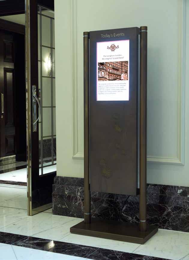 Digital lobby signs This complex construction for The Langham from bronze toned brass with a deep etched pattern design and gold leafed text is