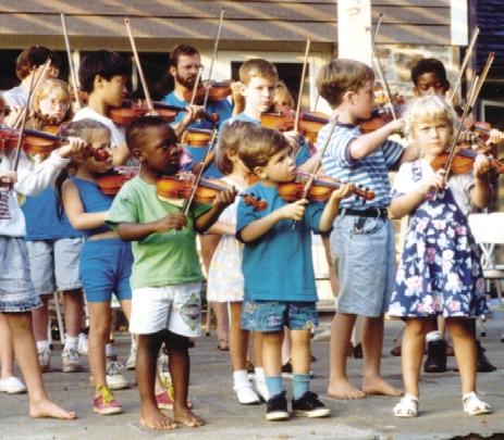 A group of children perform Andantino at an outdoor concert from memory. the first to the second session [r=.803, p<.01].