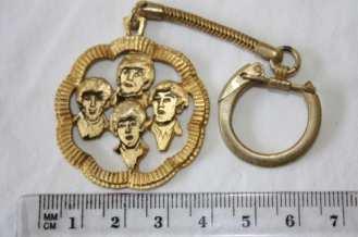 Beatles brass brooch containing head