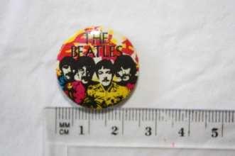 Yellow and Black button with Beatles in group.