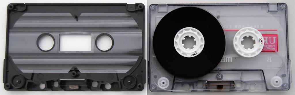 Carefully separate the upper half of the shell from lower half (make sure that the tape reels and all small parts stay in position within the lower half of the shell).